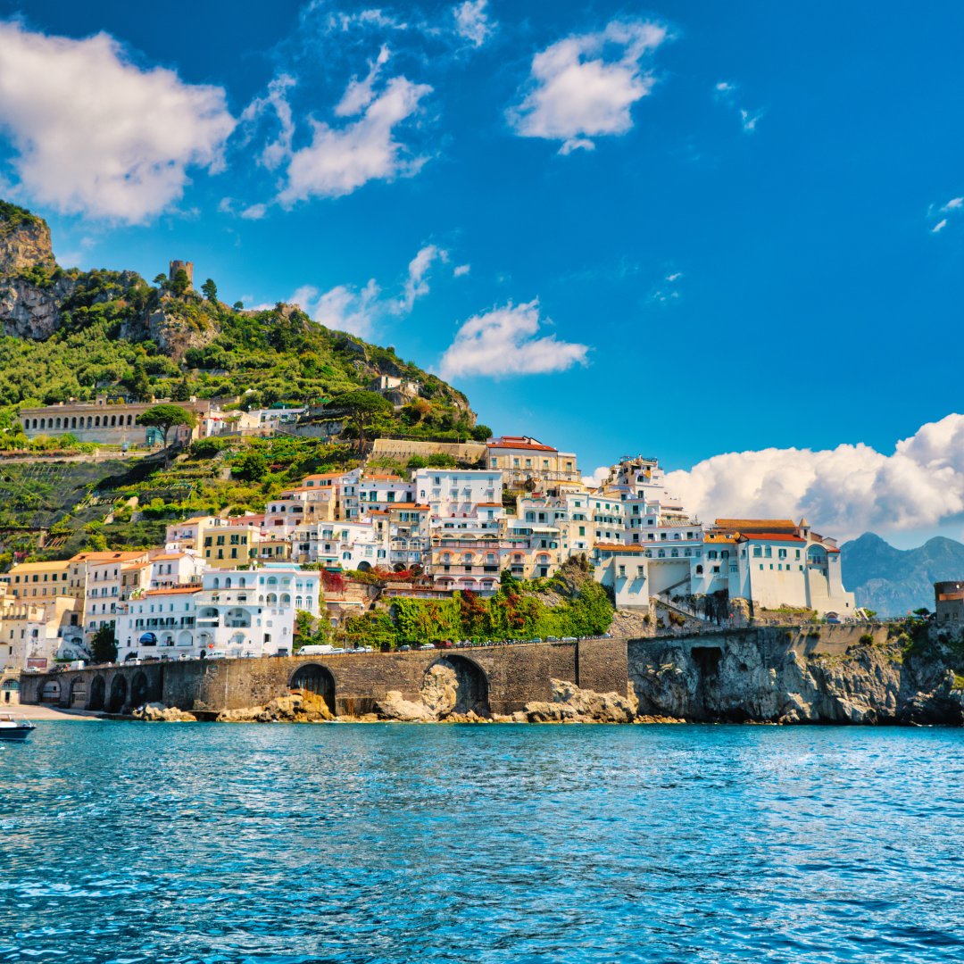 Aerial view of Amalfi town with its harbour and the medieval Torre dello Ziro on the hillside, southern Italy